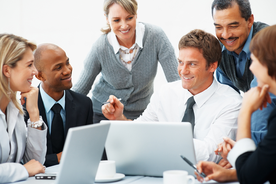 Executives-With-Laptops-During-meeting Group of executives smiling during meeting